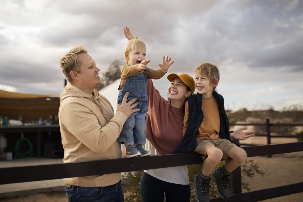 Parents Lifting and Playing with Children Outdoors
